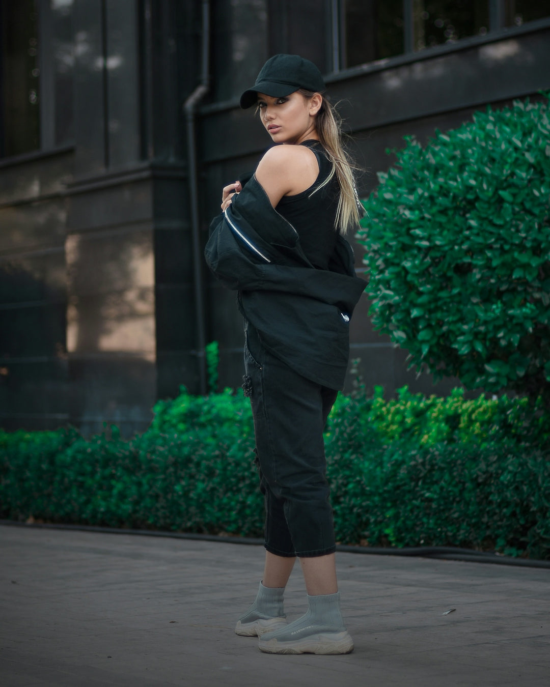 a woman in a black outfit and a hat