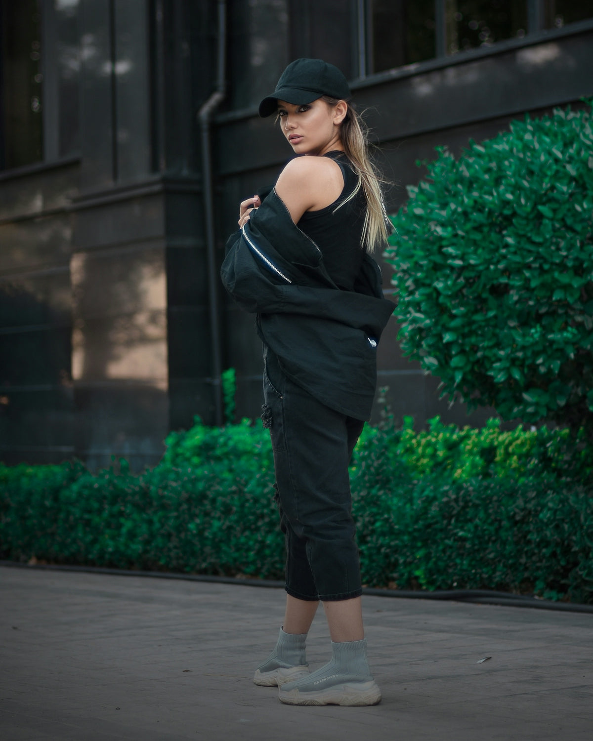 a woman in a black outfit and a hat