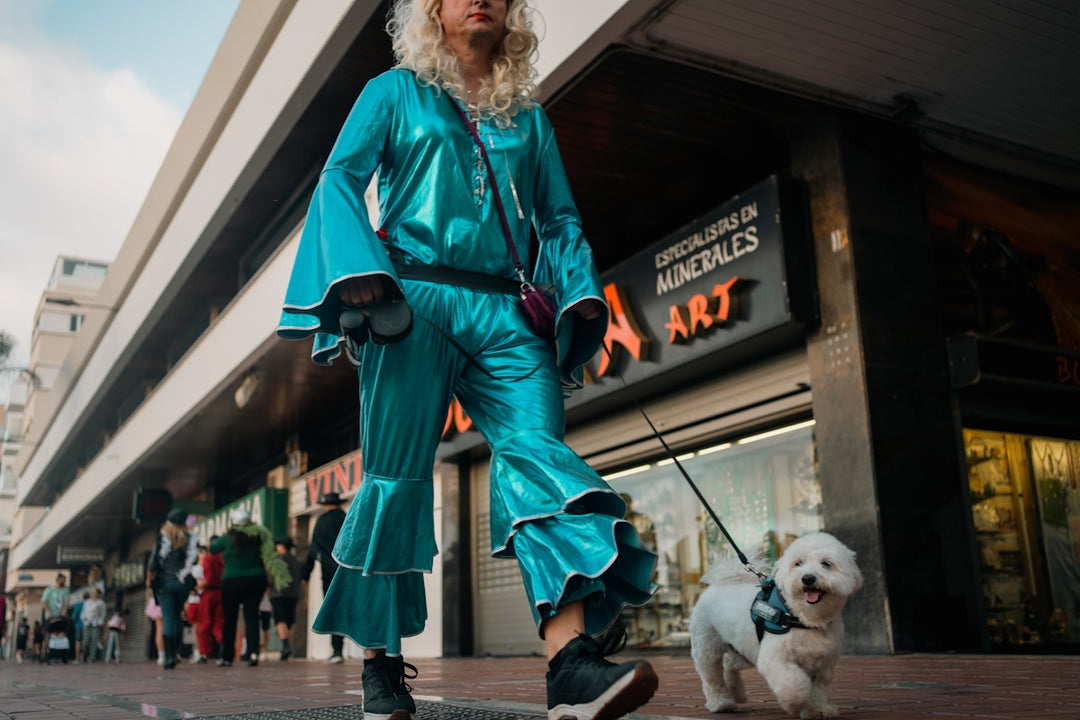 A woman in a blue outfit riding a skateboard