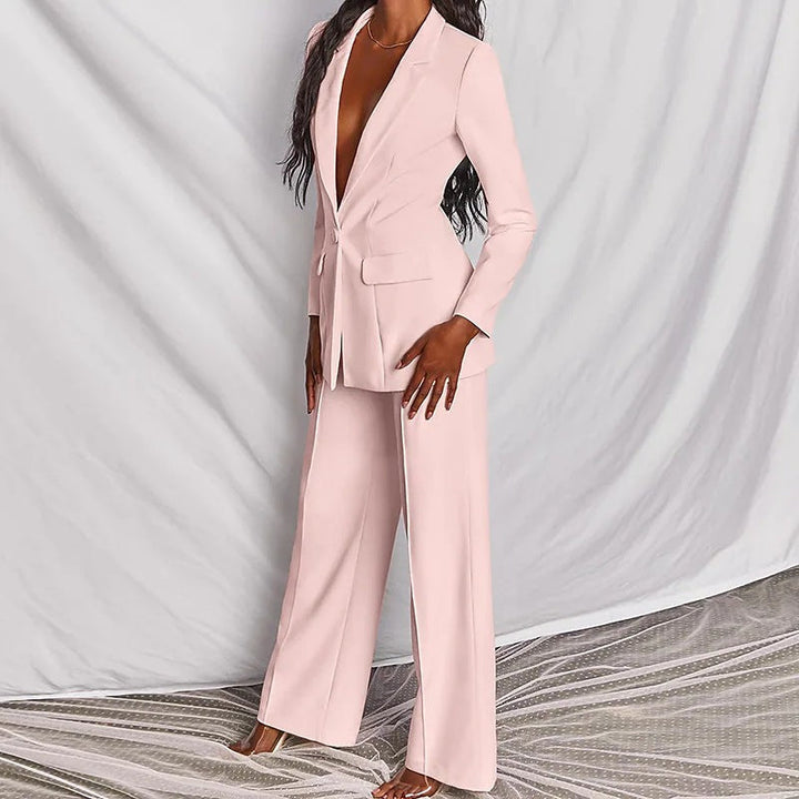 Frau in einem zartrosa Anzug mit weitem Bein und tiefem Ausschnitt. Eleganter Hosenanzug für Damen. IsabellBoutique030